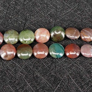 May include: A strand of round, flat, multi-colored agate beads. The beads are a mix of green, brown, and red.