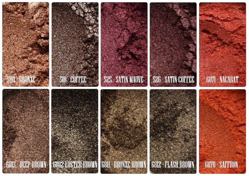 May include: Close-up of ten different eyeshadows in various shades of brown, red, and orange. The eyeshadows are labeled with their names and numbers. The eyeshadows are arranged in two rows of five.