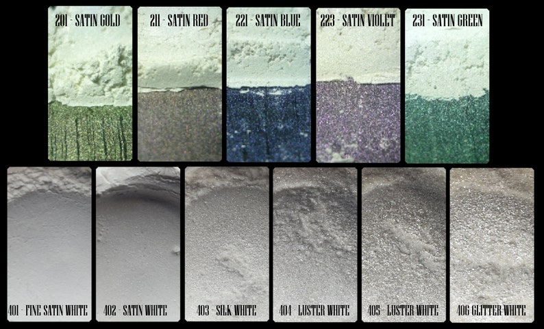 May include: A collection of cosmetic pigments in various colors, including gold, red, blue, violet, and green, with names like "Satin Gold" and "Satin Red." The bottom row features white shades such as "Fine Satin White" and "Glitter White."