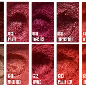 May include: A collection of ten samples of red and pink pigments, each with a unique shade and name. Shades range from Red Pearl to Bright Red, with names like Peach, Rose Red, and Mauve. The samples are displayed in small, square containers.