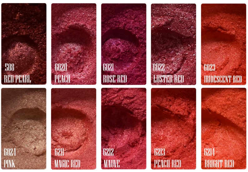 May include: A collection of ten samples of red and pink pigments, each with a unique shade and name. Shades range from Red Pearl to Bright Red, with names like Peach, Rose Red, and Mauve. The samples are displayed in small, square containers.