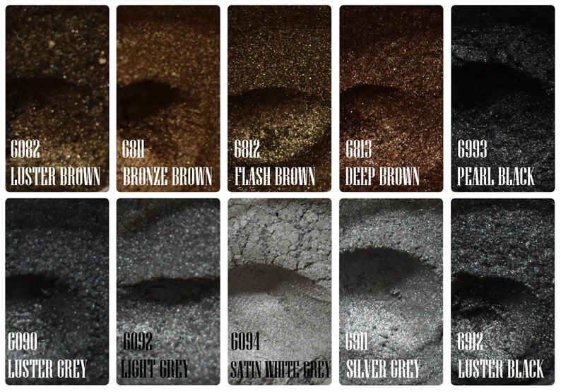 May include: A collection of ten samples of metallic pigments in various shades of brown, gray, and black. Each sample is labeled with a color name and a code number. Colors include Luster Brown, Bronze Brown, Flash Brown, Deep Brown, Pearl Black, Luster Grey, Light Grey, Satin White Grey, Silver Grey, and Luster Black.