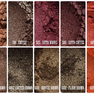 May include: A collection of ten shimmering eyeshadow shades in various brown, bronze, and reddish hues. Each color is labeled with a number and name, including "Bronze," "Coffee," "Satin Mauve," and "Saffron."