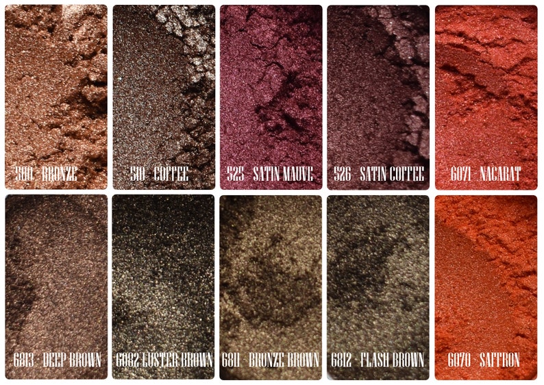May include: A collection of ten shimmering eyeshadow shades in various brown, bronze, and reddish hues. Each color is labeled with a number and name, including "Bronze," "Coffee," "Satin Mauve," and "Saffron."