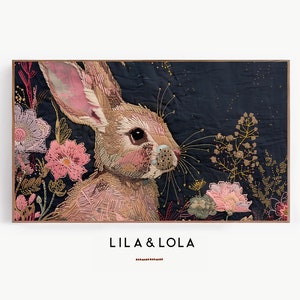 May include: An embroidered rabbit with long ears and a fluffy tail, surrounded by pink and purple flowers on a dark blue background. The image is titled "Lila & Lola".