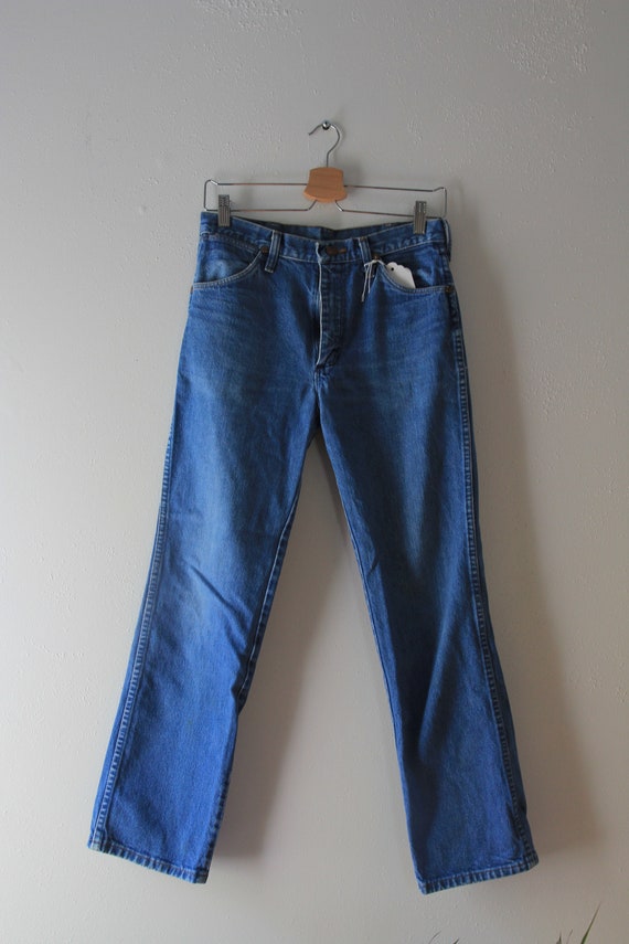 medium wash 28'' waist Wranglers