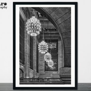 May include: Black and white photograph of a grand hall with a high arched ceiling and rows of ornate chandeliers hanging from the ceiling.