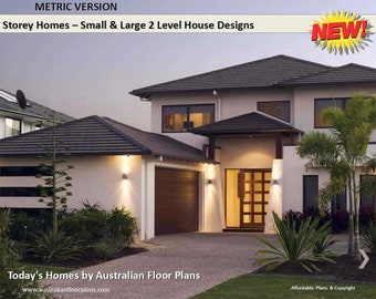 May include: A two-story house with a white exterior and a black tiled roof. The house has a large front door with a glass panel and a garage door on the left side. The house is surrounded by landscaping, including palm trees and shrubs.
