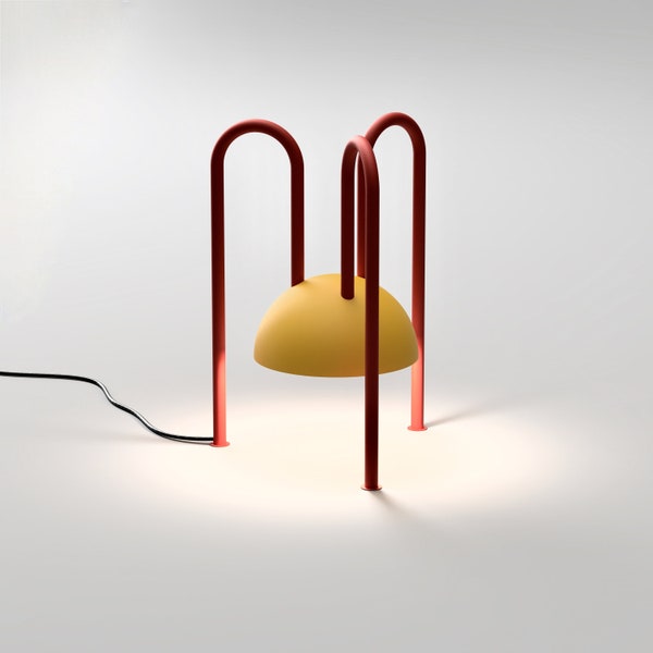 ALLUGI modern geometric table lamp from Balance Lamp with a yellow globe and red legs