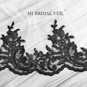 May include: Black floral lace trim with intricate detailing. The lace features a repeating pattern of flowers and leaves, creating an elegant border. The text "MI BRIDAL VEIL" is visible in the image.