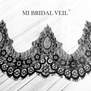 May include: Black lace trim with a scalloped edge, featuring floral and teardrop patterns. The text "MI BRIDAL VEIL" is displayed at the top. The trim is set against a light wood grain background.