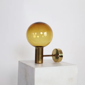 Brass Sconce with a Golden-Brown Glass Shade by Hans Agne Jakobsson | Sweden | 1960s