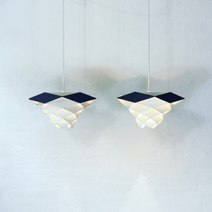 A pair of white and gray SYMFONI pendant lights by Preben Dahl