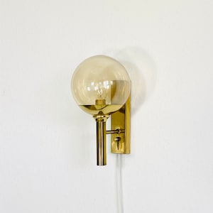 A brass wall lamp by Svend Mejlstroem | 1960s | Denmark