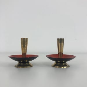 A pair of miniature candlestick holders in style of Herbert Krenckel
