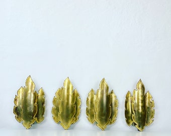 A quartet leaf-shaped brass sconces designed by Holm Sorensen