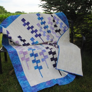 Handmade throw of Lupine flowers in batiks of shades of blue, pink, and purple