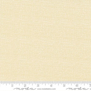May include: Cream-colored fabric with a textured, grid-like pattern. The design features a network of thin, white lines overlaying a soft, pale yellow background. The fabric is suitable for quilting and other craft projects.