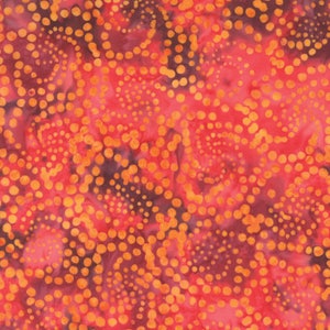 May include: Red and orange fabric with a swirling pattern of small orange dots. The fabric has a batik style.