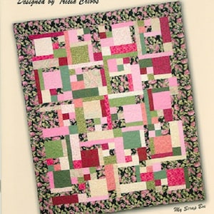 May include: A colorful quilt with a patchwork design featuring pink, green, and cream-colored squares and rectangles. The quilt is bordered with a floral pattern and includes the text "Turning Twenty... Again" and "You Can Make This Quilt Today!"
