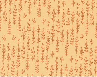 May include: A beige fabric with a repeating pattern of orange stylized leaves. The fabric has a subtle texture and is marked with a ruler in inches.