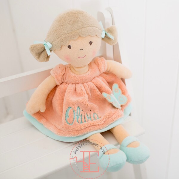 Personalised brown haired soft rag doll wearing fleecy peach dress with butterfly motif