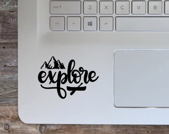 May include: A black and white sticker with the word "explore" written in a stylized font. The sticker also features a simple illustration of mountains.