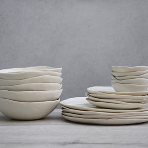 48 white porcelain plates and bowls. Set for 12 people: 12 dinner plates, 12 pasta bowls, 12 side plates, 12 small bowls. Handmade in Italy