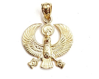 May include: A gold pendant featuring a detailed design of the Egyptian goddess Isis with outstretched wings. The pendant is made of solid gold and has a polished finish.