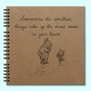 May include: A brown notebook with a spiral binding features a quote from Winnie the Pooh and Piglet: "Sometimes the smallest things take up the most room in your heart."