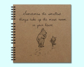 May include: A brown notebook with a spiral binding features a quote from Winnie the Pooh and Piglet: "Sometimes the smallest things take up the most room in your heart."