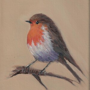 May include: Oil painting of a European robin perched on a branch. The bird has a vibrant orange breast, a brown head, and gray wings. The artwork is set against a neutral beige background, with the artist's signature in the lower left corner.