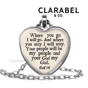 May include: A silver heart-shaped pendant necklace with a white background and black text that reads "Where you go I will go. And where you stay I will stay. Your people will be my people and your God my God. Ruth 1:16"