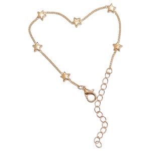 A gold-colored bracelet with small star-shaped charms attached to it.