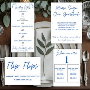May include: Wedding details sign with blue calligraphy, a guest book sign with blue calligraphy, a flip flops sign with blue calligraphy, and a table number sign with blue calligraphy. The table number sign has two photo placeholders with instructions to paste a photo in the box and use these dimensions: 2.2 x 3.3 inches.
