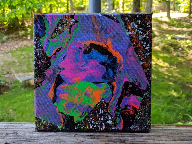 May include: Abstract painting on canvas with swirling patterns in shades of purple, pink, green, blue, orange, and black. The background is black with white speckles.