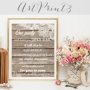 Puede incluir: Un letrero de madera rústica con detalles de encaje blanco y el texto "Our party will have an OPEN BAR it will also be HEAVILY PHOTOGRAPHED any drunken shenanigans will be well documented and thoroughly mocked For years to come Proceed with caution!"