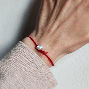 Red bracelet with pearl - braided from fine superkid mohair yarn - delicate handmade jewelry