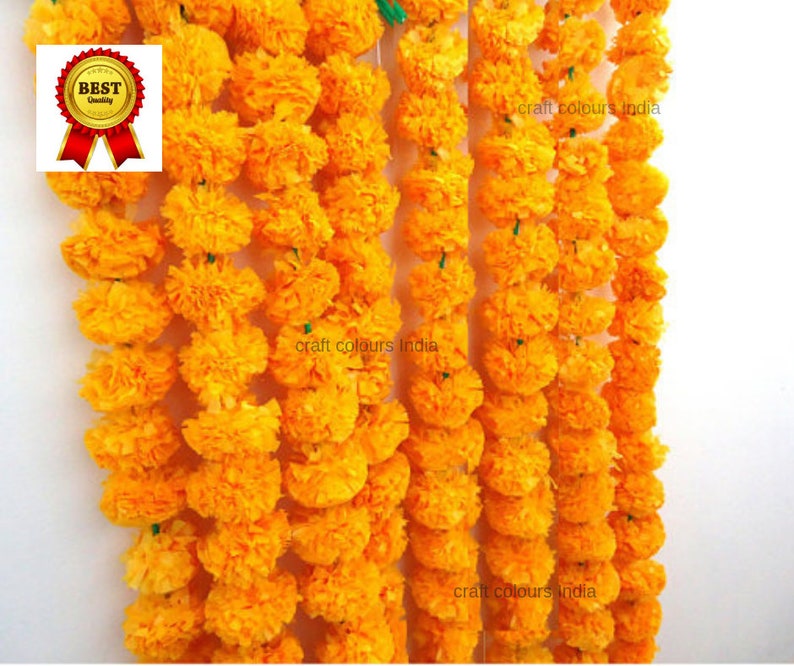 May include: A garland of yellow marigold flowers, strung together with green thread. The garland is made of paper and is a popular decoration for Indian festivals and celebrations.