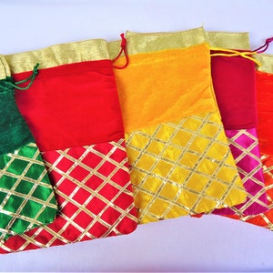 May include: Five colorful drawstring bags with gold trim and a diamond pattern. The bags are made of velvet and have a variety of colors, including green, red, yellow, pink, and orange.