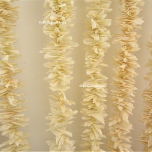 May include: A close-up of a cream-colored paper garland, with the text "Craft Colours India" printed on two of the garlands.