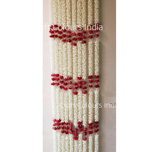 May include: White and red flower garland, with the text "Craft Colours India" visible in the image.