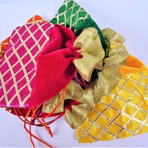 May include: A set of five colorful drawstring bags with gold trim. The bags are made of velvet and satin and have a diamond pattern. The bags are perfect for gifts or favors.