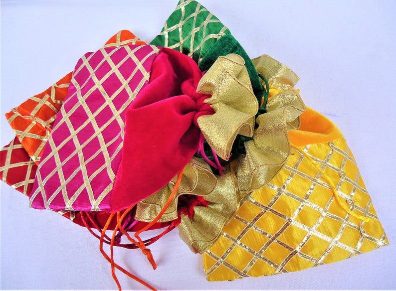 May include: A set of five colorful drawstring bags with gold trim. The bags are made of velvet and satin and have a diamond pattern. The bags are perfect for gifts or favors.
