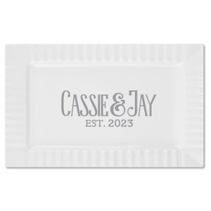 May include: White rectangular serving tray with a raised rim and a gray inscription that reads "Cassie & Jay EST. 2023".
