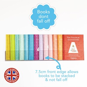 May include: A clear acrylic bookshelf with a 7.5 inch front edge to prevent books from falling off. The bookshelf is filled with colorful books, including "The Tailor of Gloucester" by Beatrix Potter. The text "Books dont fall off" is written on a blue cloud shape.