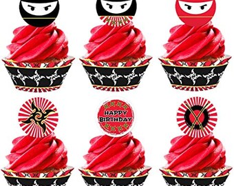 May include: Set of 6 ninja-themed cupcake wrappers and toppers. The wrappers are black and white with a ninja star design. The toppers feature a red and black ninja mask, a red and black ninja with swords, and a red and white "Happy Birthday" banner.