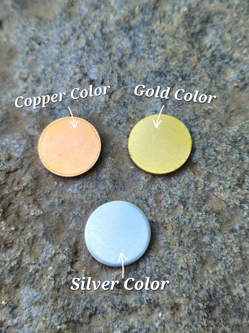 May include: Three circular flat discs arranged in a triangular formation. One disc is copper-coloured, one is gold-coloured, and one is silver-coloured. Each disc is labelled with text pointing to it: Copper Color, Gold Color, and Silver Color.