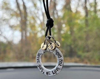 May include: A silver charm necklace with a round charm that says "Drive Safe, We Love You Dad". The charm has three smaller charms attached to it with the letters "F", "D", and "Z" on them.