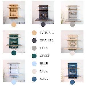 May include: A wall-mounted folding desk with shelves in various colors, including natural wood, granite, grey, green, blue, milk, and navy. The desk has a fold-down tabletop and two shelves for storage.
